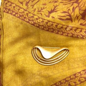 Bright gold costume pin from 1990s